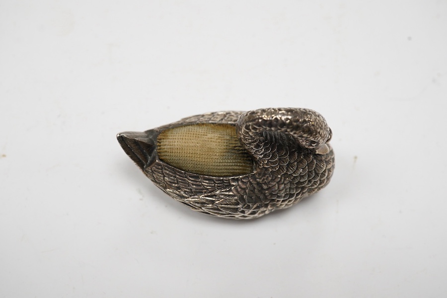 A modern silver mounted swan pin cushion, Ari D Norman, London, 1988, length 59mm. Condition - fair